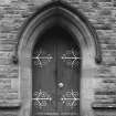 View of door with decorative hinges.