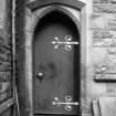 View of door with decorative hinges.