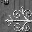 Detail of decorative hinges on door.