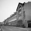 Oblique view from NW of W end of main facade overlooking Buccleuch Street.