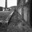 View from NW along path of lade on NE side of main block.