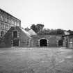 View from N of single storeyed W wing of main block.