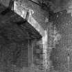 Detail showing spandrels, voussoirs and steel bracing of railway bridge at N end of station, over B6405 road.