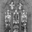 Interior. Chancel. Detail of stained glass 3-light pointed arch window to E gable