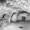 Interior.
Ground floor, central vaulted chamber, S wall from NE.