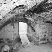 Interior.
Ground floor, SE barrel vaulted chamber, detail of kitchen fireplace in E wall during reconstruction.