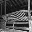 Interior.
Detail of hay heck in cattle shed.