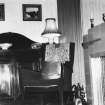 Interior.
View of living room showing chimneypiece, chair and sideboard.