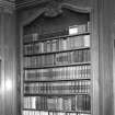 Interior. Octagonal library detail of panelling and bookcase