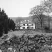 General view from E across garden showing setting.