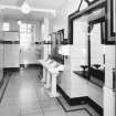 Interior.
Gentlemen's toilet, view from S showing original wash hand basins and 'Vitrolite' panels.