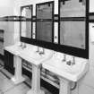 Interior.
Gentlemen's toilet, detail showing original wash hand basins, etched mirrors with shooting, diving and house designs, and 'Vitrolite' panels.