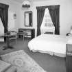 Interior.
First floor, SE bedroom, view from NW showing 1930's furniture.