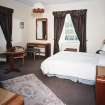 Interior.
First floor, SE bedroom, view from NW showing 1930's furniture.