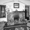 Interior.
Lounge, detail of c. 1970 fireplace with 1930's niche.  The 1930's fireplace was a larger version of the one in the private sitting room.