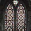 Interior. Detail of 2-light pointed arch stained glass window