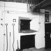 Interior.
View of oven and implements.