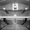 Interior. 
View from E showing raked seating, box pews and gallery.