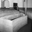 Interior. 
Detail of curved box pews.