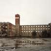 General view from W across yard showing N Mill, water tower, Burnside Mill and W Mill.