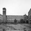 View from W across yard showing N Mill, water tower, Burnside Mill and W Mill.