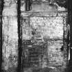 Interior.
View of remains of bolection moulded fireplace on E wall of ground floor apartment.