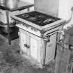 Interior. 
Detail of old gas-fired stove in kitchen area.