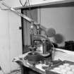 Interior. 
Detail of Scotch pie crust moulding machine in the pie-crust gallery with a tray of completed crusts.