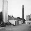 Alloa, Whins Road, Brewery
View from NNW of main switch room buildings with carbon dioxide tank behind, chimney and mill room area over brewhouse pend. The building which housed the switch gear dates from 19th-century. The carbon dioxide from the tank was used in the brewing finishing process, whereby it was used to pressurise vessels and keg containers