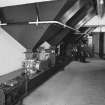 Alloa, Whins Road, Brewery, Barns Block, first floor, interior
View of bottom of the four 5 tonne malt bins dating from 1950s with automatic rotary valves installed in 1994 (these give measured amounts of grain). These bins hold chocolate and crystal malts which are measured. These are then mixed in malt bin 'E' with bulk grain and carried by conveyors to the mill room for milling. All the systems are incorporated into an automatic controlled Redler conveyor and elevator system