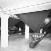 Alloa, Whins Road, Brewery, Barns Block, basement floor, interior
View of bottom of the nine 45 tonne grain silos. Bulk grain was stored here until a mix is required by the mill room. The correct ratio of chocolate, crystal and bulk are mixed and sent to the weigh hopper (or bin 'E') on the top floor