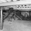 Alloa, Whins Road, Brewery, Barns Block, fourth floor, interior
View of top of the malt bins and grain silos. The intake conveyor is visible in the background. The four malt bin shutes are on the right. The intakes to the nine silos are partially visible on the left. Bin 'E' (where the mix of crystal, chocolate and bulk malt is mixed) is also situated on third/fourth floors