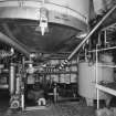 Alloa, Whins Road, Brewery, Brewhouse, interior, basement
View of underside of mash tun no. 2. with trub vessel on right. The trub vessel contains deposits left after the wort is pumped from the copper to the whirlpool where residual sediments are removed by a centrifuge