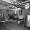 Alloa, Whins Road, Brewery, Wort Cooling area, interior
View of two stainless steel paraflow or heat exchangers which can deal with some 135 barrels per hour. After the wort is pumped from the whirlpool it is cooled, using chilled liquor, from boiling point to about 10-16 degrees centigrade (depending on the brew) in about 2 hours. The cooled wort is then be transferred to the fermentation area. Other stainless steel vessels on the right are used in the routing of detergents around the brewery (not in situ)