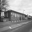View from SW, with the former power loom shed in the foreground