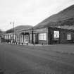 View from SE showing S side of mill, fronting onto West Stirling Street.  This, and the more ornate power loom shed beyond, used to be three-storeys high, but were reduced to one after a fire in 1941.