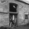 Detail of original arched opening in threshing barn.