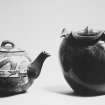 View of teapot and scallop-edged vase.