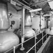 Interior.
View of still room.
View of three steam-heated stills, L to R: No 1 low wines still, 9587 litres; wash still; No 2 low wines still, 7628 litres, all R. & G. Abercrombie of Alloa, dated 1962.  Rosebank is one of only two triple-distilled whiskies in Scotland.