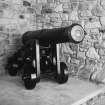 Field cannon (one of two) presently preserved in office block. Bears plate inscribed; "9 pounder gun no 55287/cast at Carron 1797/ Despatched to Carron Warehouse/London, per the 'Polly'/William Honey man, Master/ On Saturday 29th April 1797/Weight 1 ton 4 CWT".