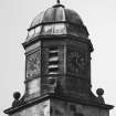 Detail of upper stages of clock tower from E.