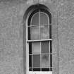 Detail of window with decorative keystone in SE elevation.