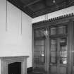 Interior.
Entrance hall, showing glazed screen and fireplace.