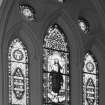 Interior, detail of stained glass at East end by WJJ Keir 1870 of Ascension of Christ flanked by texts and four evangelists