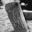 View of chamfered edge on rear face of reused medieval gravestone set on end.