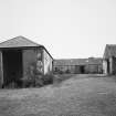 View of steading buildings adjacent to farmhouse from NE.