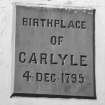 Detail of plaque commemorating birth of Thomas Carlyle on NE elevation.