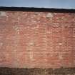 Detailed view from E of brickwork of E side of former Quinan stove or drying house, building R18, showing blocked pipe openings which would have connected it to its adjacent apparatus house.  Each Quinan stove/ drying house appears to be 15 bays long.