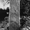 Artifically lit view of medieval graveslab in reuse as gatepost on S side of entrance, NY 2577 8019.