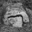 View of socket stone outside SE corner of churchyard.